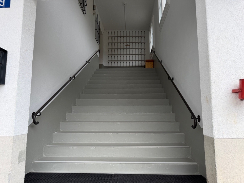 An external staircase leads to the entrance.